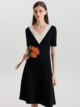 A lady wears a black midi dress.